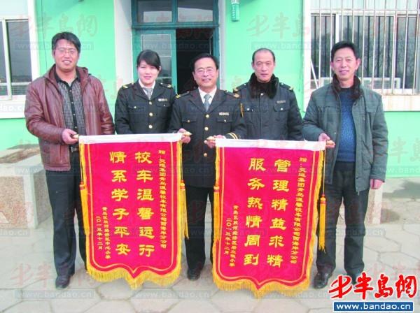 膠河經(jīng)濟(jì)區(qū)中心小學(xué)的工作人員給溫馨校車膠河路隊(duì)工作人員送來錦旗。